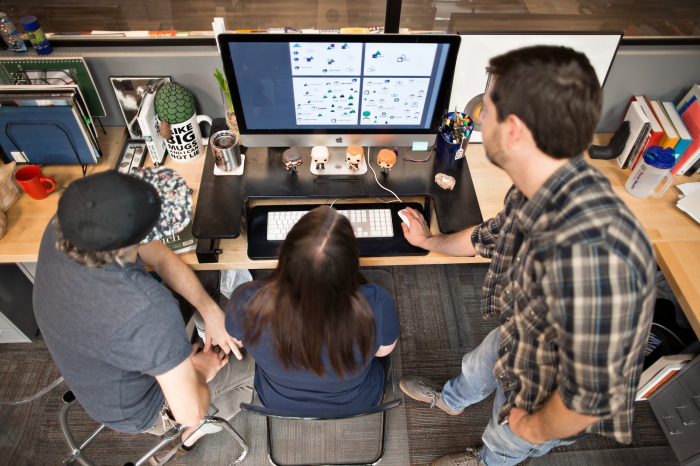Designers showing each other something on a project on their computer
